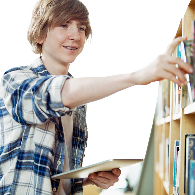 Teenage boy reaching for a book